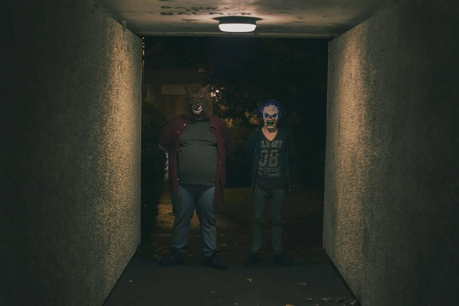 a couple of people that are standing in a hallway